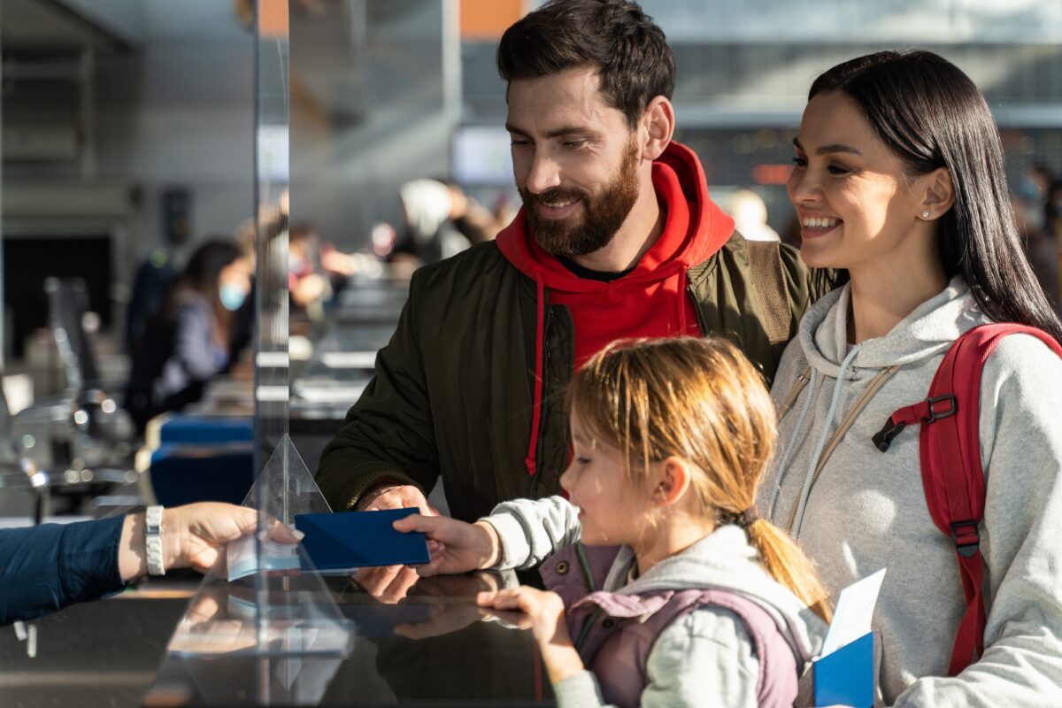 Passengers checking in at an airport counter