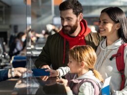 Passengers checking in at an airport counter