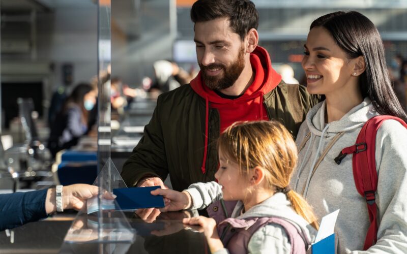 Passengers checking in at an airport counter