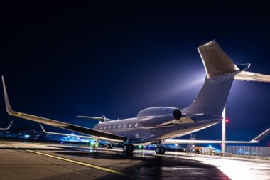 Business jet parked at night