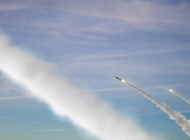 Military rockets are flying against the sky