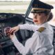 Lady pilot posing for the camera in the cockpit