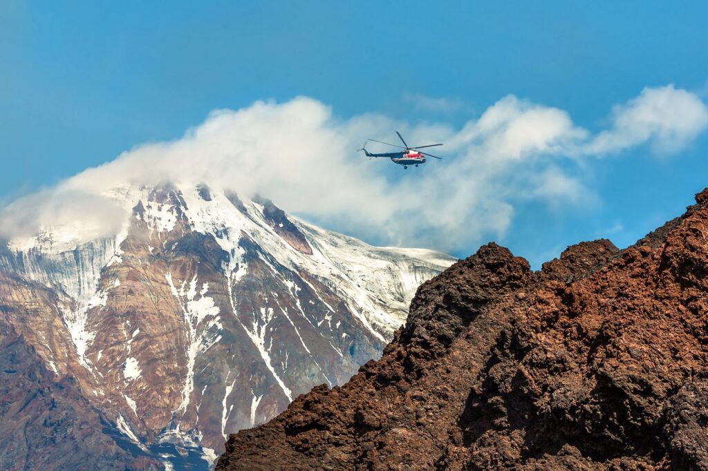 A helicopter flies in Kamchatka, Russia