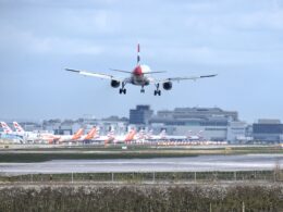 British Airways Airbus A320 landing at London Gatwick Airport LGW with multiple British Airways and easyJet aircraft in the background