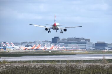 British Airways Airbus A320 landing at London Gatwick Airport LGW with multiple British Airways and easyJet aircraft in the background