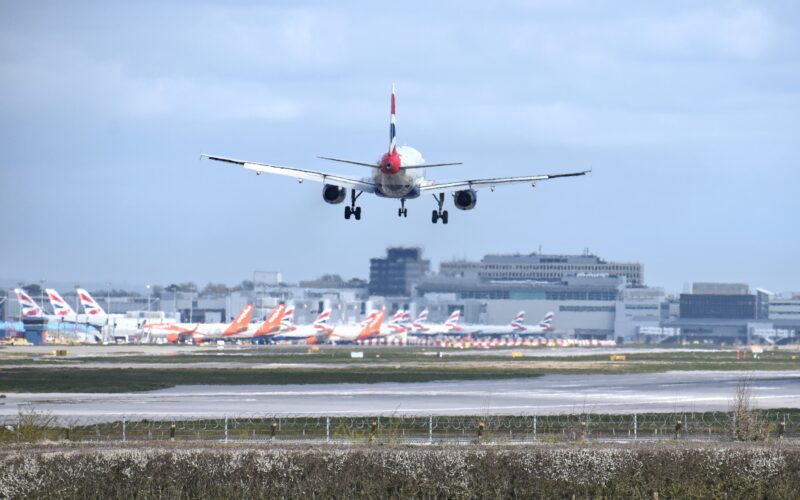 British Airways Airbus A320 landing at London Gatwick Airport LGW with multiple British Airways and easyJet aircraft in the background