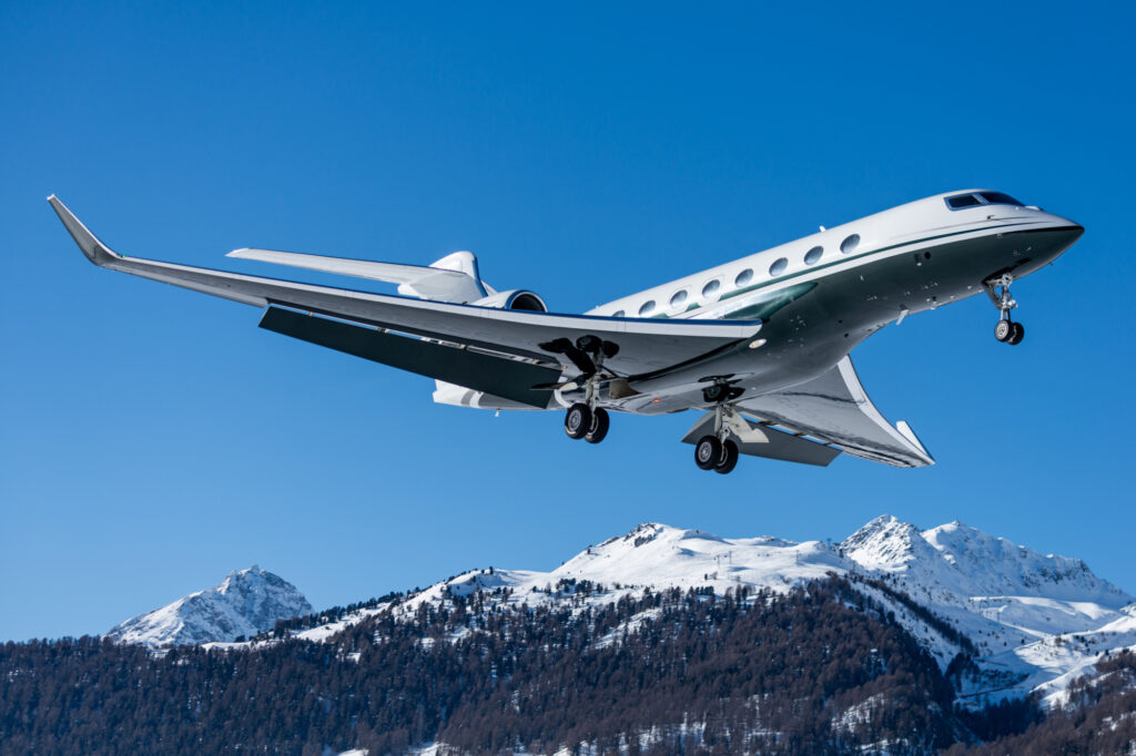 Business jet during landing at Engadin airport during the winter holidays in Switzerland