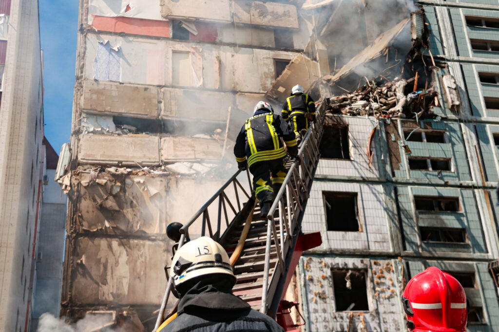 Rescuers at a residential building hit by a missile in Uman