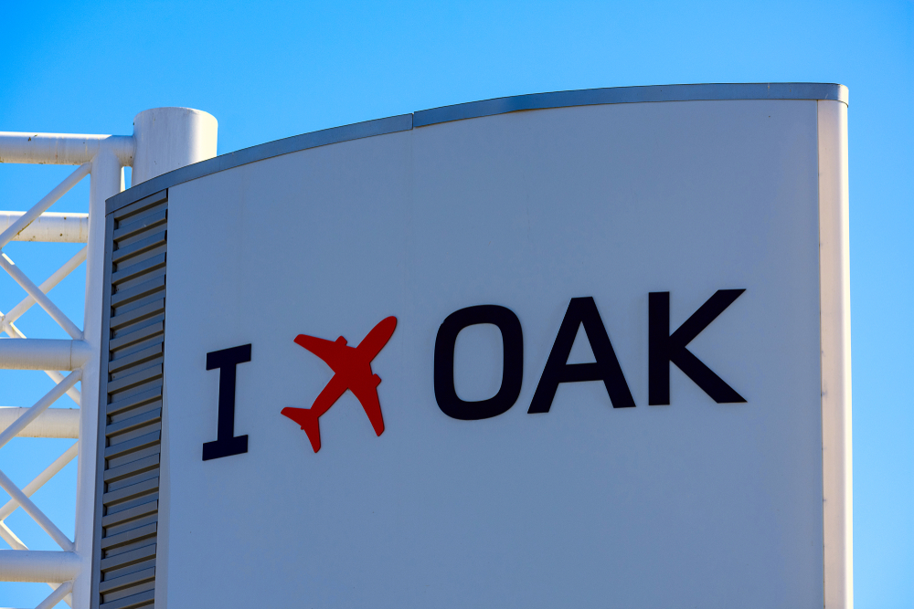 I,Fly,Oakland,Sign,With,Red,Airplane,Logo,On,The