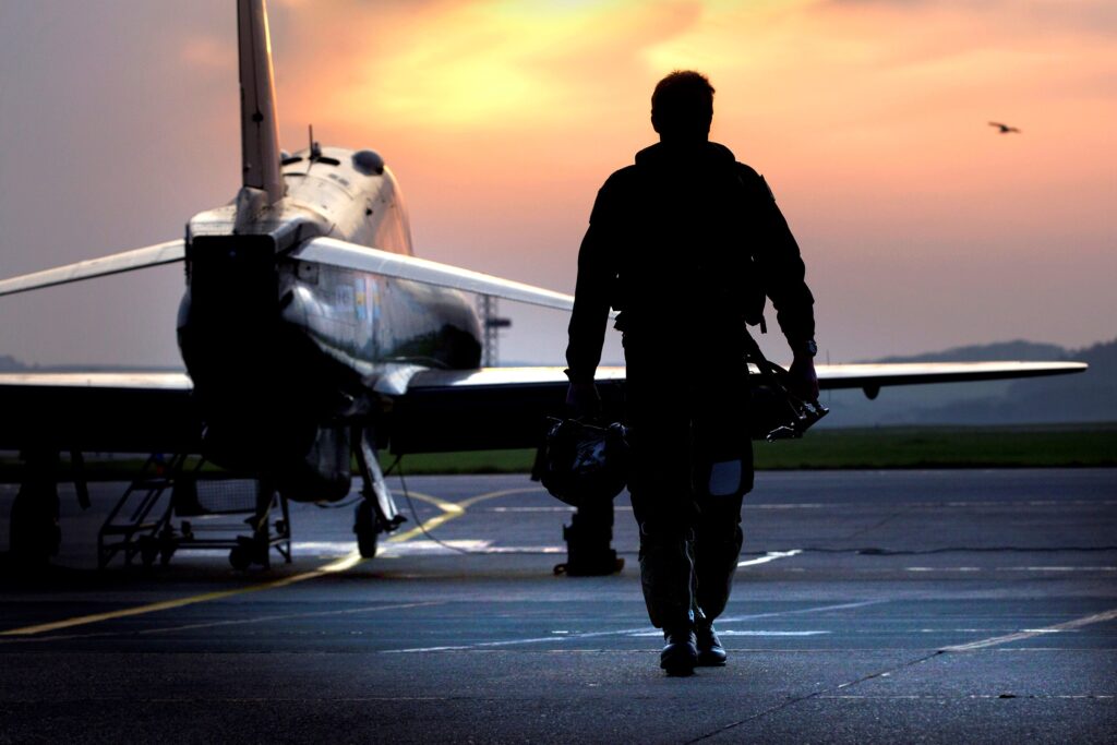 RAF Pilot Walking Away from Hawk Aircraft in Silhouette