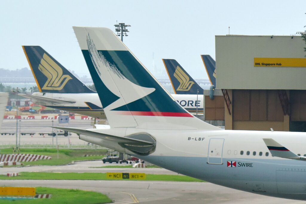 Tails of Cathay Pacific and Singapore Airlines aircraft at Changi Airport