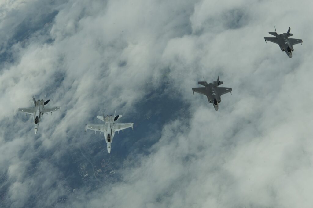 U.S. Air Force F-35s and Finnish Air Force Hornets flying in formation