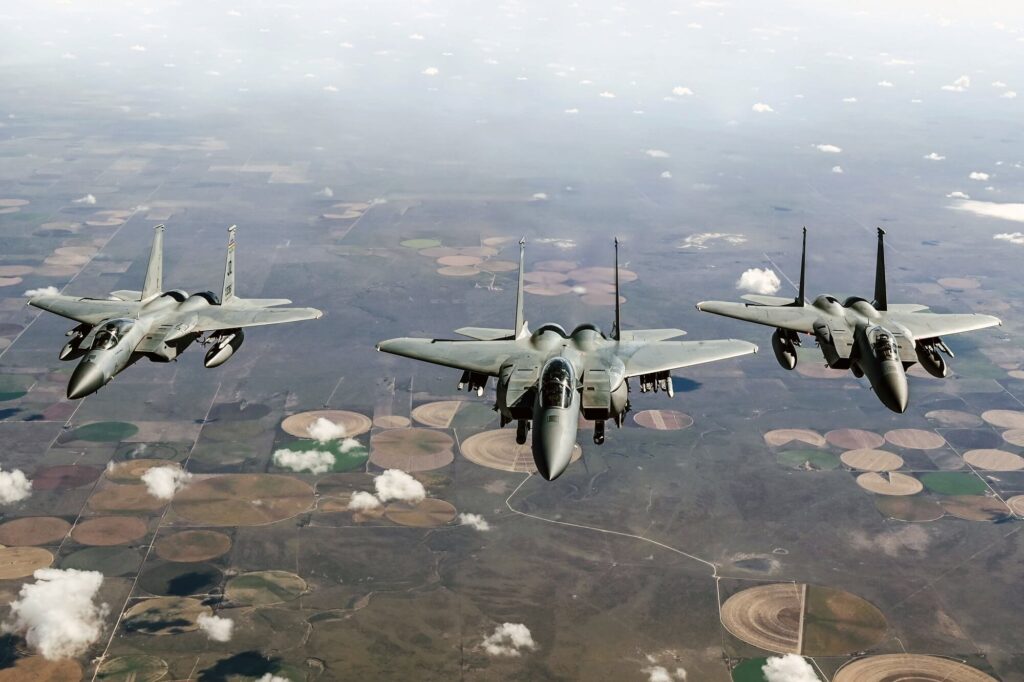 an_f-15ex_eagle_ii_flying_alongside_two_f-15c_fighters.jpg