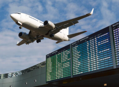 boeing_737_overflying_an_airport_flight_time_board.jpg