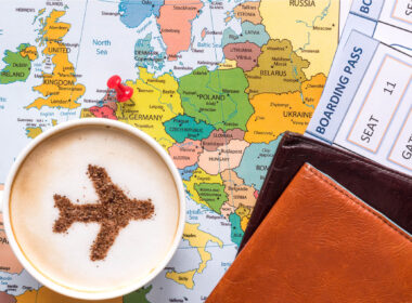 capuccino_passpord_and_a_boarding_pass_over_the_map_of_europe.jpg