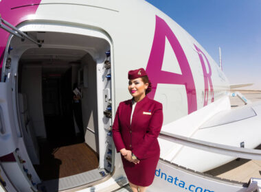 qatar_airways_flight_attendant_welcoming_passengers_on_board_an_airbus_a380.jpg